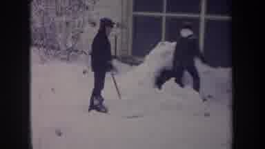 Michigan USA (1968): Two Kids And A Dog Shoveling Snow And Building A Small Igloo