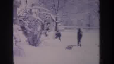 Michigan USA (1968): Three People Wearing Winter Hats And Jackets Going Sledding