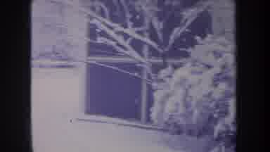 Michigan USA (1968): Snow Covered Buildings And Dog Running On Clear Winter Day