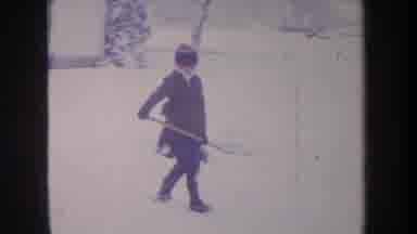 Michigan USA (1968): Two Young Boys In The Snow One Is Shoveling While The Other