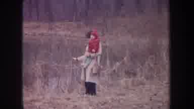 Michigan USA (1968): Woman Holding A Small Child Wearing A Redcoat Outside At The