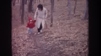 Michigan USA (1968): Mom Wearing Winter Coat Holding Her Little Son Hand Walking