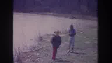 Michigan USA (1968): 2 Children Outside Near A Body Of Water And A Woman Pulling A