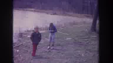 Michigan USA (1968): Footage Of Two Children Playing Lakeside On Hill With A Stick