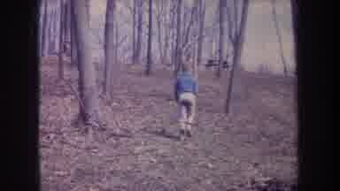 Michigan USA (1968): Boy In Blue Shirt Walking With Stick In Bare Woods And Woman