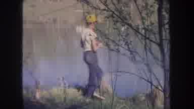 Michigan USA (1968): Boy Wearing Yellow Hat And Blue Jeans Is Fishing In The Lake