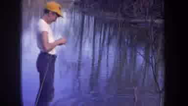 Michigan USA (1968): Two Boys Fishing With Rod And Reel One Boy Baits A Hook