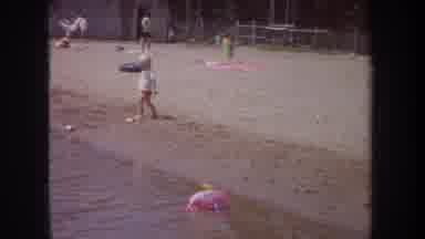 Michigan USA (1968): Child Playing By The Shoreline Of A Lake
