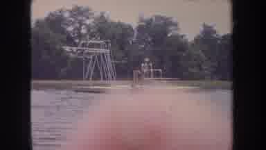 Michigan USA (1968): Young People Jumping And Diving Off Of A Diving Board On A