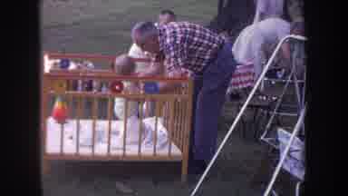 Michigan USA (1968): Family Gathering Outside Sitting In Chairs Old Man Playing