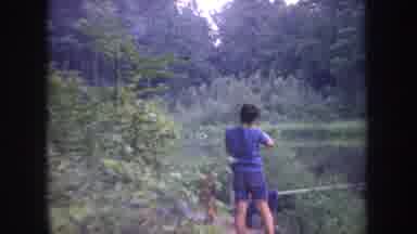 Michigan USA (1968): Man And Boy Catch A Fish On The Edge Of A Body Of Water