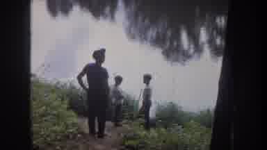 Michigan USA (1968): Man And Two Children Stand On Riverbank Gazing At Reflection