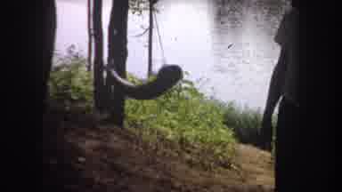 Michigan USA (1968): Person With Live Fish On The Line Near Lake