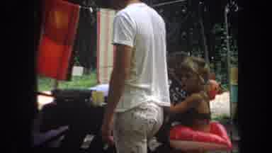 Michigan USA (1968): People Camping With Man Cooking On Bbq And Girl In Swimming