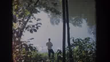 Michigan USA (1968): Man In White Shirt Peacefully Fishing Aside A Calm Pond Among