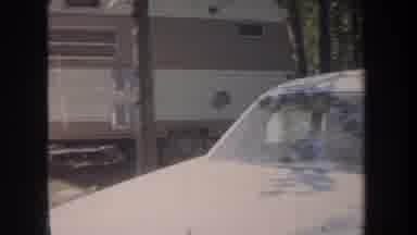 Michigan USA (1968): Rv Trailer And Beige Car On A Quiet Campsite With A Blue