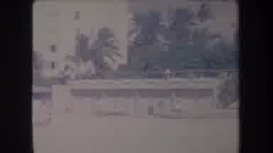 Hawaii USA (1969): Outside A Beach A Man Standing Near A Tennis Court Palm Trees