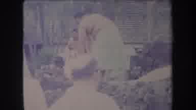 Hawaii USA (1969): Two Men Starting Fire For Luau While Others Watch Cooking While