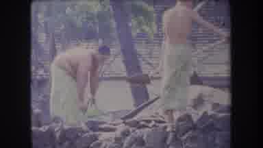 Hawaii USA (1969): Men In Towels Digging With Shovels On Beach On Sunny Day