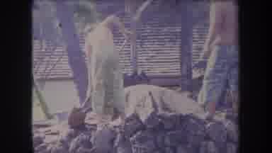 HAWAII USA-1969: Men Working With Shovels And Rocks In Tropical Village