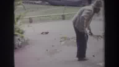Hawaii USA (1969): Old Woman Sweeps Street With Homemade Broom On Pleasant Day