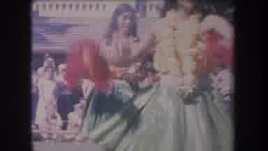 Hawaii USA (1969): Two Young Women Dancing Wearing Hawaiian Garlands Watched By
