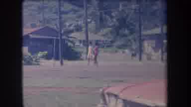 Hawaii USA (1969): Two People Are Walking Through The Village Road With Some