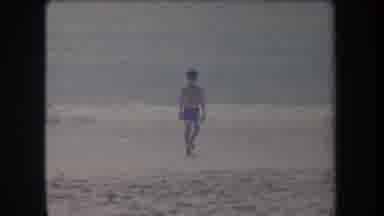 Hawaii USA (1969): Man Walking On The Beach Sand After A Dog Runs Running Wanting