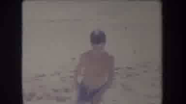 Hawaii USA (1969): Kids On The Beach Standing And Splashing In Water