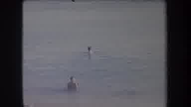 Hawaii USA (1969): A Child Enters Beach Water In Attempt To Swim Towards Woman In