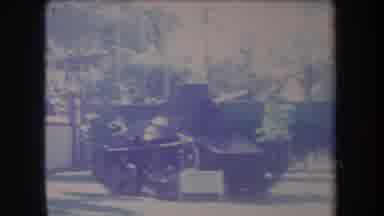 Hawaii USA (1969): Car Passes House On Road With Old Tank Nearby With Palm Trees