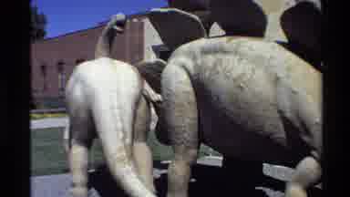 Western USA (1980): Statue Of Three Green And White Dinosaurs Standing In Front Of