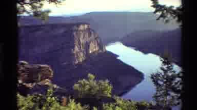 Western USA (1980): Staring Off The Side Of A Deep Valley With A Calm Stream Of