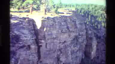 Western USA (1980): Large Cliff With Beautiful Lake In The Forest