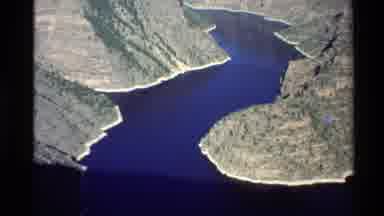 Western USA (1980): River Running Between A Canyon With Steep And High Striated