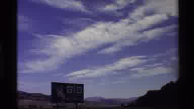Western USA (1980): Big Billboard In Open Countryside With Mountains In The