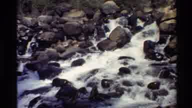 Western USA (1980): Water Rushing Down A Short Waterfall With Large Brown Rocks