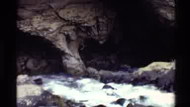 Western USA (1980): Creek Flows Over Rocks And Into A Cave