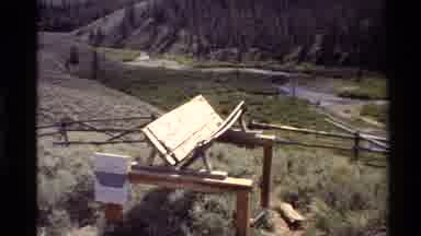 Western USA (1980): Wooden Structure Surrounded By Wood Fence In Green Field Near