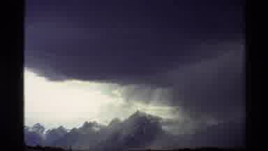 Western USA (1980): Sun Peeking Through Clouds Over Mountains Wind Moving Storm