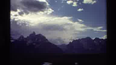 Western USA (1980): Mountain Range And Green Plain In Front Of A Cloudy Sky