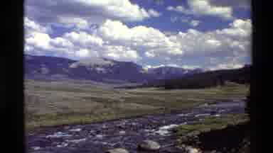 Western USA (1980): Sky And Clouds Mountains Near River With Grass Plains