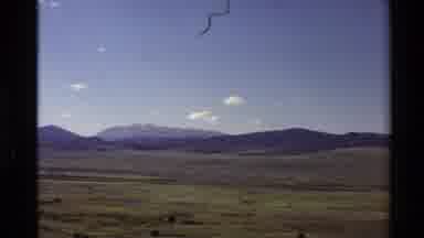 Western USA (1980): Field Mountain Sign Sky Wood Sign Direction Grass Bushes