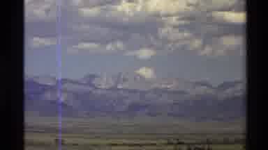 Western USA (1980): Landscape Showing Mountain Range With White Fluffy Clouds