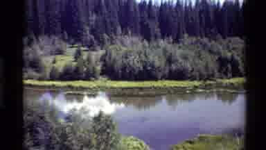 Western USA (1980): A Grassy Shore Surrounds A Lake And Then The Camera Zooms