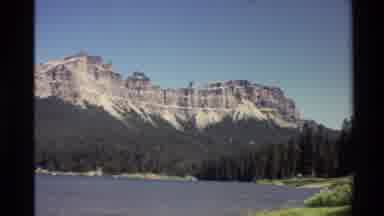 Western USA (1980): Mountain Range Next To A Lake With A Beach Of Grass On The