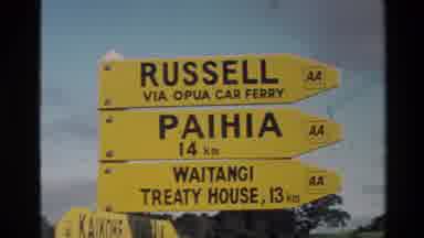 New Zealand (1981): Yellow Car Ferry Sign And Mountains And Lake On A Cloudy Day