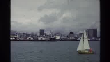 New Zealand (1981): Sail Boat Sails Across A Body Of Water In An Urban Area