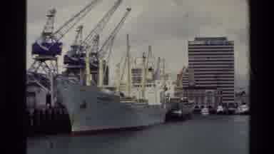 New Zealand (1981): Camera Looks At Boats Off A Harbor In A City