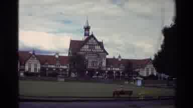 New Zealand (1981): People Playing Croquet On Front Lawn Of Tan Colored Mansion